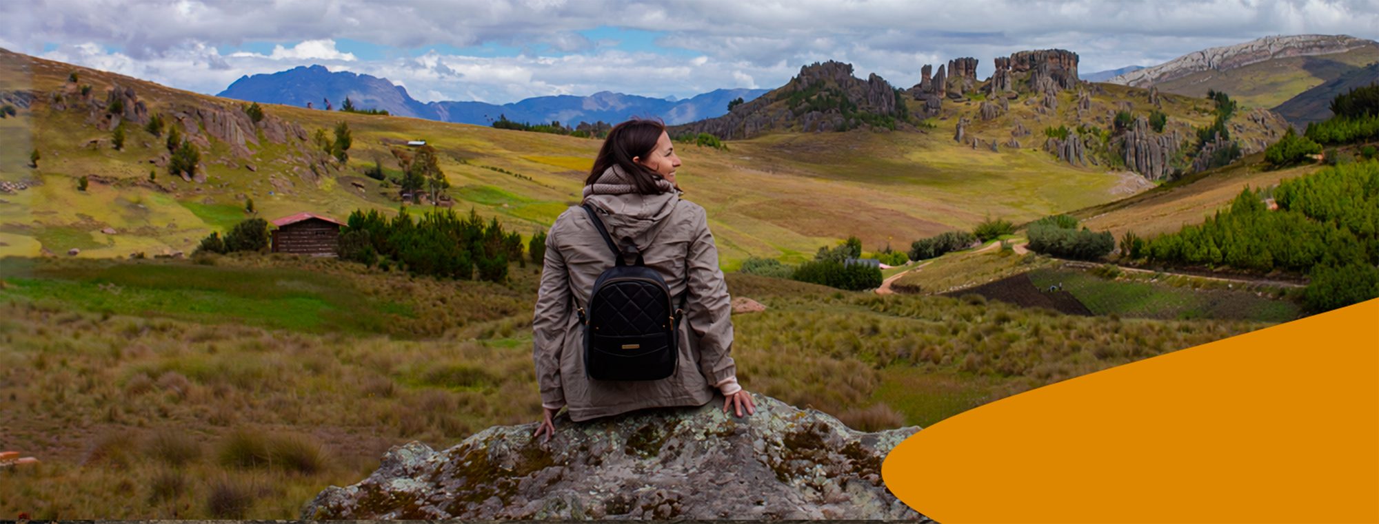 A traveller looking out over the Cumbemayo rock formations and the Cajamarca highlands