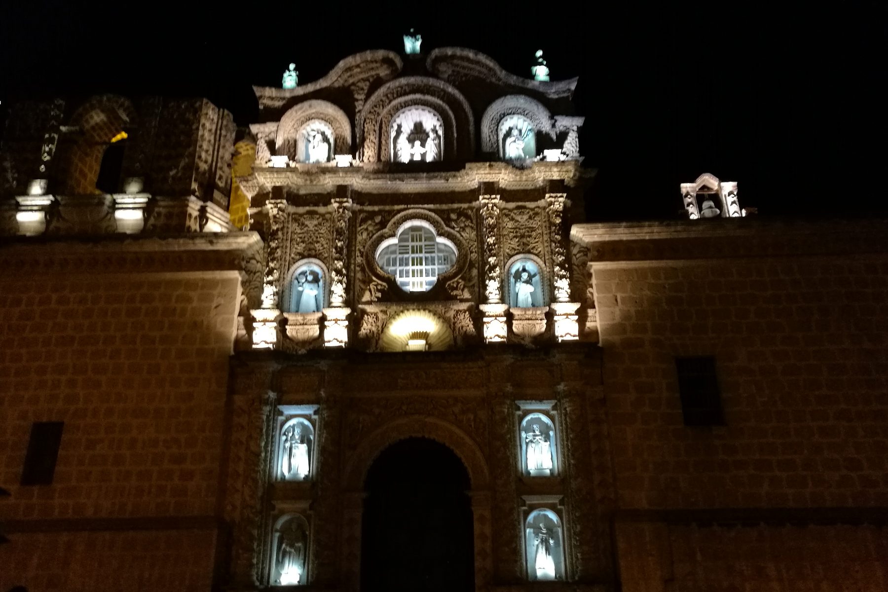 The baroque facade of the Belen church complex in Cajamarca, lit at dusk